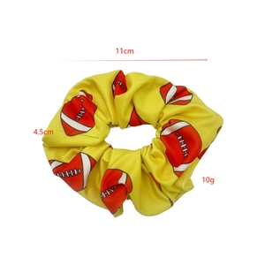 Yellow football scrunchie hair tie with white and red patterns, 11cm diameter size