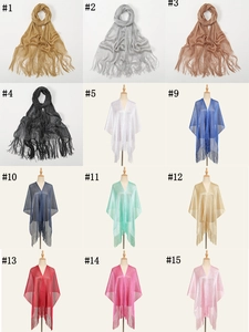 Detailed multi-color display of metallic glitter scarves with elegant fringe tassels