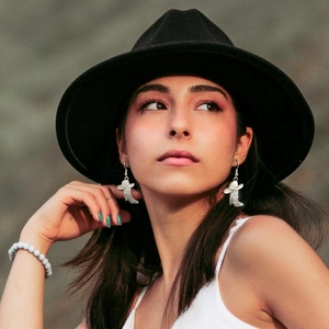 Chic silver cowboy boot earrings with sparkling zircons shown on a fashion model