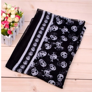 Detail of classic pirate skull print on lightweight black chiffon scarf for Halloween