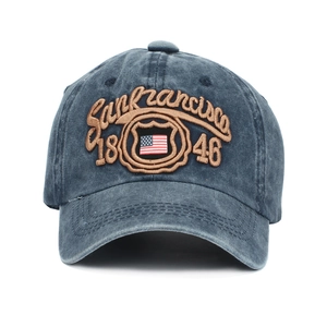 Detail view of the American flag shield and 3D embroidery on a washed navy baseball cap