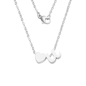 Detailed close-up of polished silver heart pendant and lowercase letter u on thin cable chain