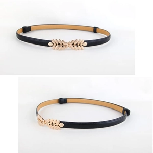 Detail of slim black PU leather belt featuring a golden leaf buckle on white background