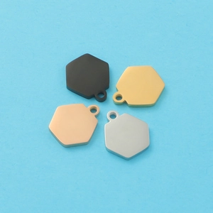 Detailed view of hexagonal stainless steel charms in four colors on a blue background