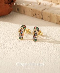 Macro shot of colorful S925 silver flip-flop earrings with vibrant zircon stones