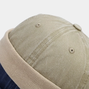 Vintage khaki washed cotton brimless docker cap with stitched panels and ribbed cuff