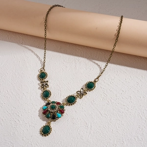 Detail of vintage palace style necklace with multi-colored crystals and floral design