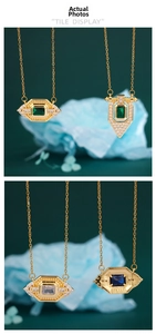Close-up of vintage gold-plated pendants with emerald and sapphire square crystals