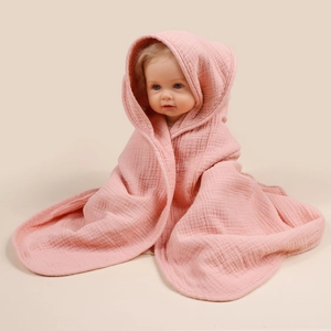 Detail of pink four-layer cotton muslin baby hooded towel with soft crinkle texture