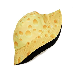 Detail shot of the creative cheese print pattern on a reversible yellow bucket hat