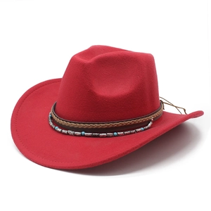 Detail of red wool felt cowboy hat featuring a turquoise beaded bohemian band decoration