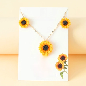 Sunflower jewelry set with yellow resin daisy necklace and earrings on a gift card