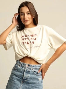 Detail of white cotton T-shirt featuring red Russian slogan print and denim skirt styling