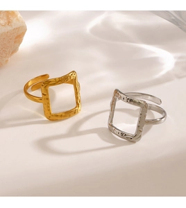 Detailed view of hammered texture on gold and silver square open adjustable rings