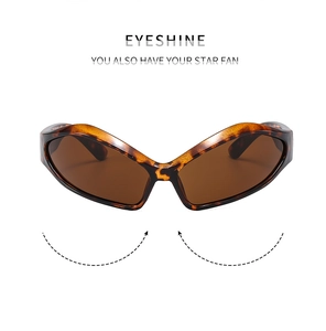 Detail view of tortoiseshell wraparound sunglasses with brown lenses and sleek retro frame