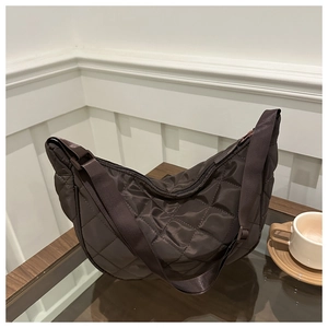 Chocolate brown quilted crescent crossbody bag with minimalist diamond stitching