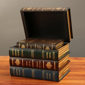 Set of four European vintage faux book storage boxes with classic embossed textures