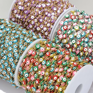 Detailed macro view of colorful Evil Eye beads on gold and silver stainless steel chains