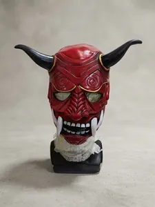 Detailed view of a red Hannya demon mask with black horns and white tusks for cosplay