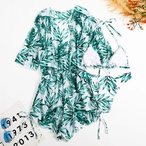 Tropical leaf print three-piece bikini set with a sheer matching beach cover-up