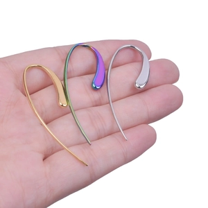 Detailed view of long waterdrop streamline earrings in gold, silver and multicolor finishes