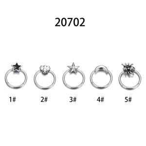 Five assorted titanium steel septum rings featuring star, bee, moon, and spider designs