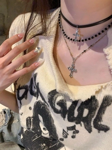 Detail of triple-layer leather and silver necklace with baroque crystal crosses
