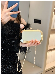 Golden geometric mirror clutch bag with chain strap styled with black evening dress