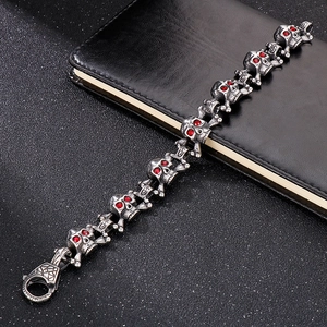 Detailed view of punk skull bracelet with red zircon eyes and vintage steel texture