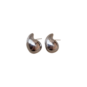 Polished silver teardrop earrings with organic metal texture on a clean white background