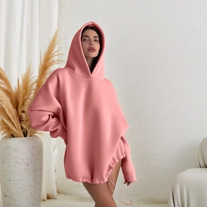 Close-up of pink oversized hoodie showing drawstring hem and premium knit texture