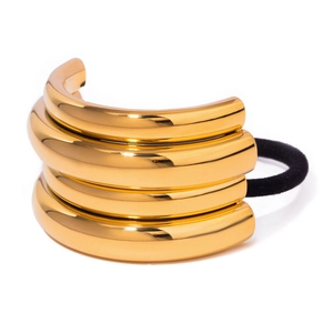 Close-up of polished gold-tone metal hair cuff with four-layer stacked design and black band