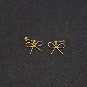 Detailed view of elegant gold bow stud earrings crafted from sleek metallic wires