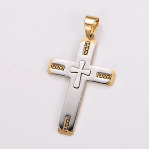 Detailed close-up of a two-tone stainless steel cross pendant with Greek key engraving