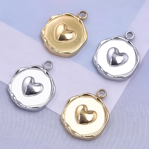 Detailed view of irregular round metal heart charms in gold and silver finish