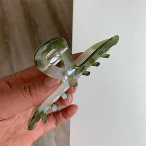 Detail showing green and white marble texture on an acetate hair claw clip