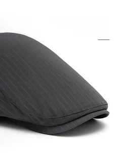 Detail of gray striped beret featuring a reinforced wide brim and premium stitching