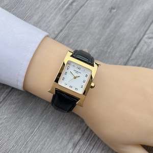 Elegant women's square quartz watch with H-shaped gold case and black leather strap