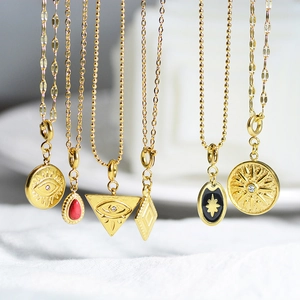 Detailed macro view of vintage gold-plated pendants with evil eye and star motifs