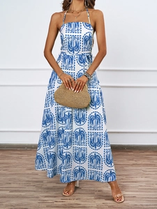 Detail of blue palm print halter dress featuring a waist belt and flowy A-line skirt