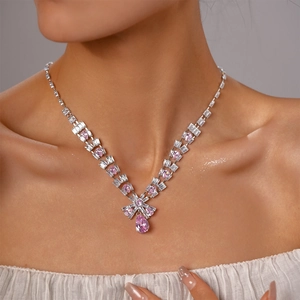 Close-up of elegant pink teardrop necklace with shimmering zircon stones on model neck