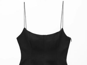 Detail of black camisole top featuring side zipper and high-quality woven fabric texture