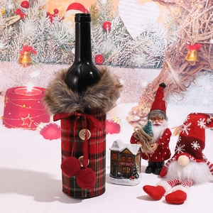 Detailed view of red and black plaid Christmas wine bottle cover with faux fur collar