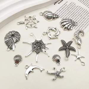 Macro view of vintage silver alloy ocean pendants showing seahorse and starfish details