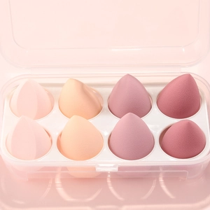 Close-up of 8-piece pink gradient makeup sponge set in a clear plastic organizer box