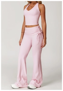 Detailed view of pink yoga set with halter neck top and drawstring high waist flared pants