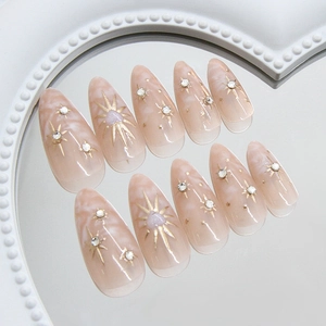 Sparkling starburst marble almond press-on nails with 3D gold details and rhinestones
