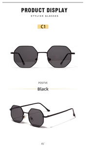 Detail view of black octagonal metal sunglasses with sleek minimalist frame and dark lenses