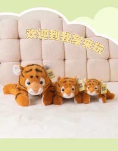 Three sizes of realistic lying tiger plush toys with soft orange stripes on a white rug