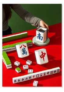Macro detail of mahjong tile ceramic mug on red table with various gaming pieces